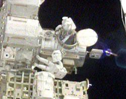 Mission Specialists John "Danny" Olivas and Jim Reilly during early moments of the spacewalk .  Credit NASA